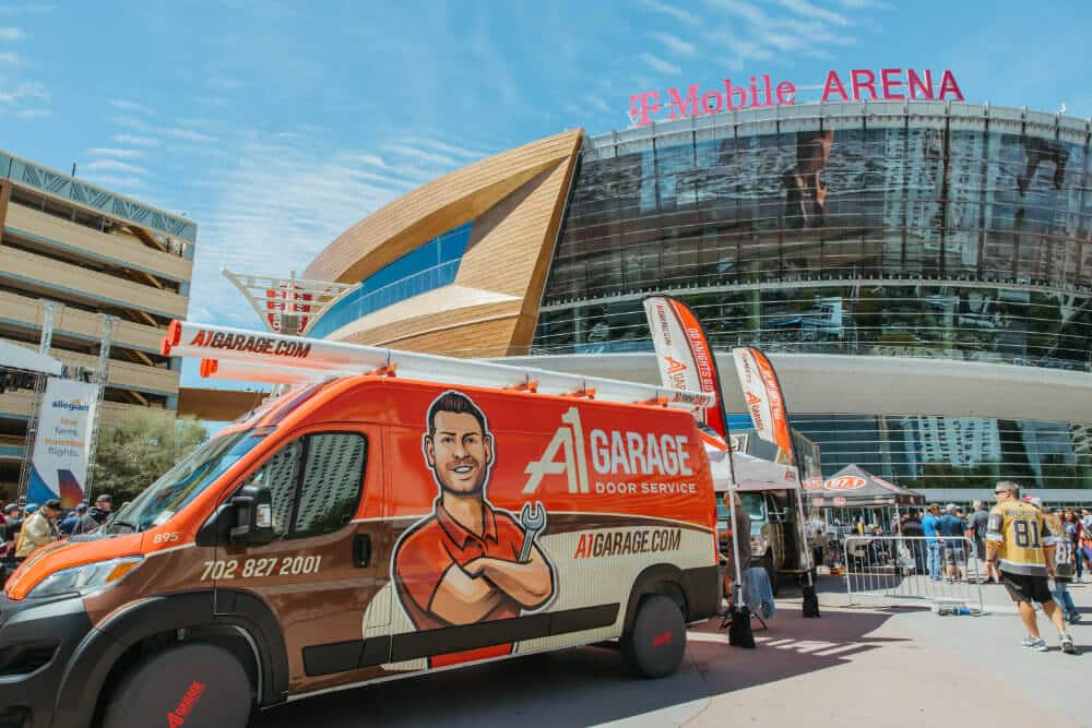 A1 Garage Door Service branded red service van outside T-Mobile Arena, showing the highly recognizable A1 brand built around a technician mascot and bold fleet graphics.