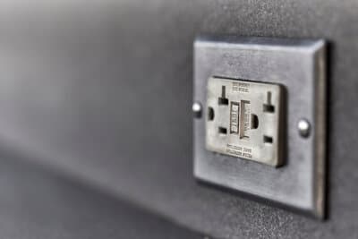 Close-up photograph of a ground-fault circuit-interrupter device, illustrating the personnel-protection technology at the center of NEC 210.8(F).