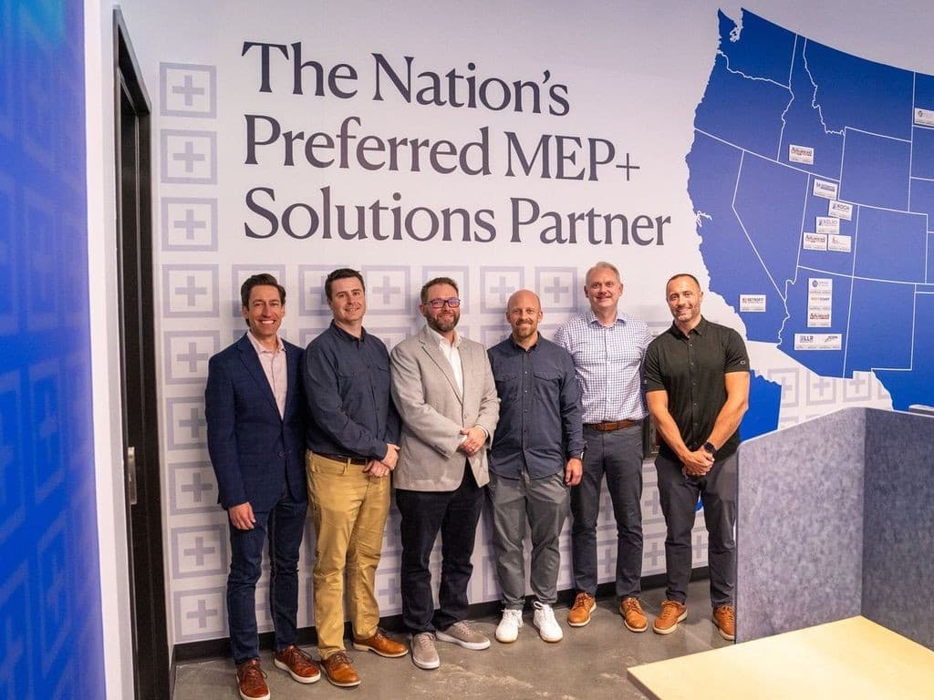 Six members of the Kelso Industries team standing in front of a wall graphic reading The Nation's Preferred MEP+ Solutions Partner beside a map of western United States operating locations.