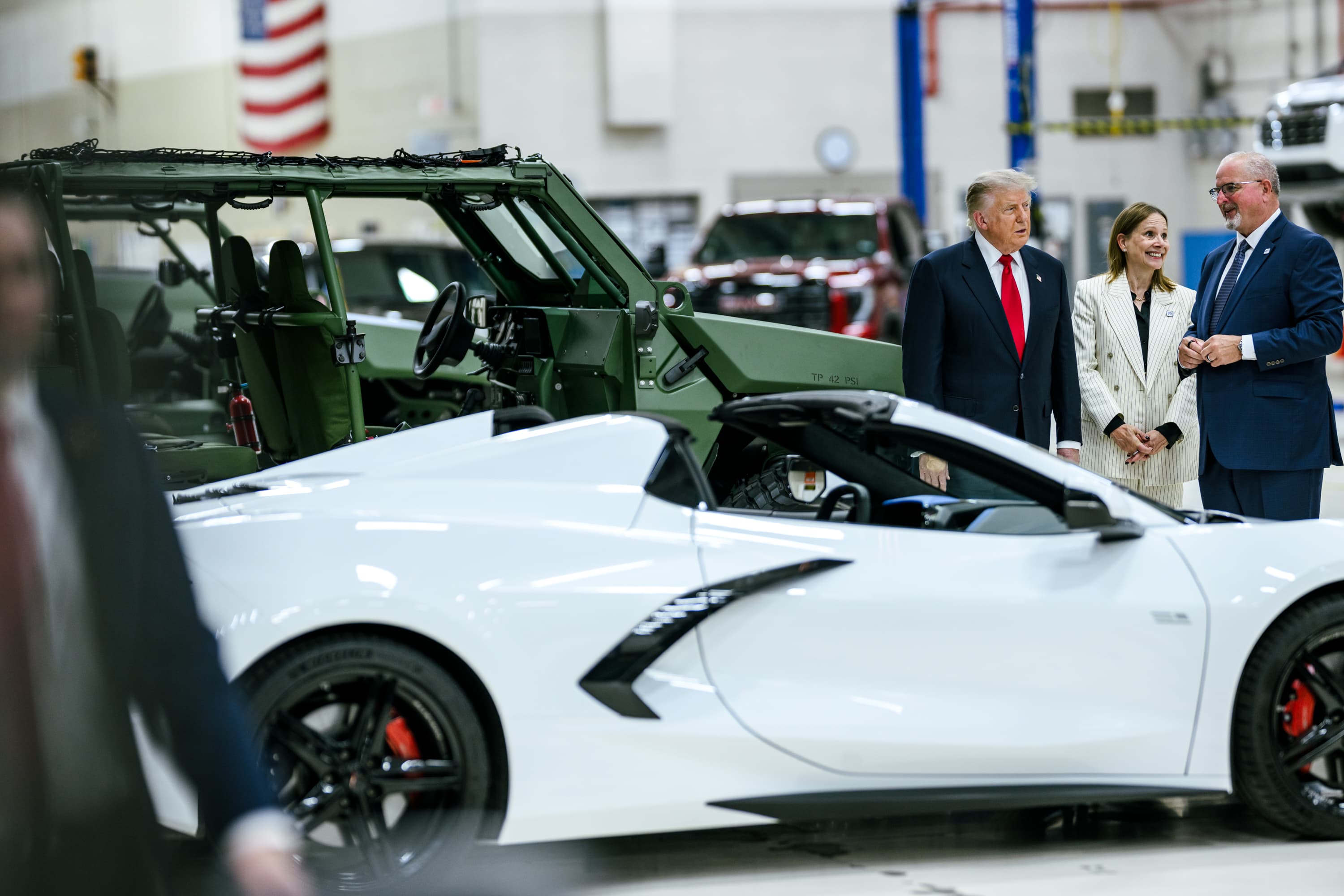 General Motors CEO Mary Barra stands with federal officials beside vehicles inside the General Motors Proving Ground in Milford, Michigan, in July 2026.