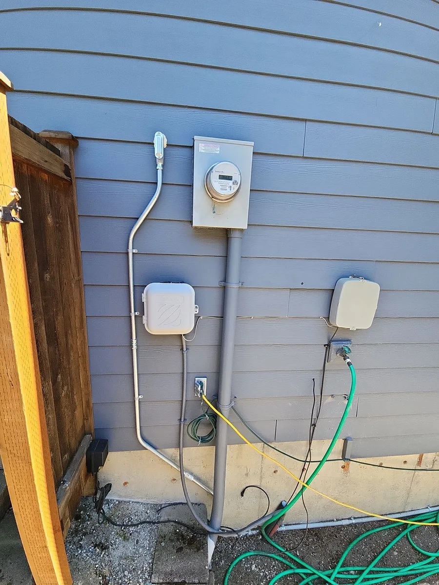 Exterior electrical boxes and conduit on the siding of a Brier property