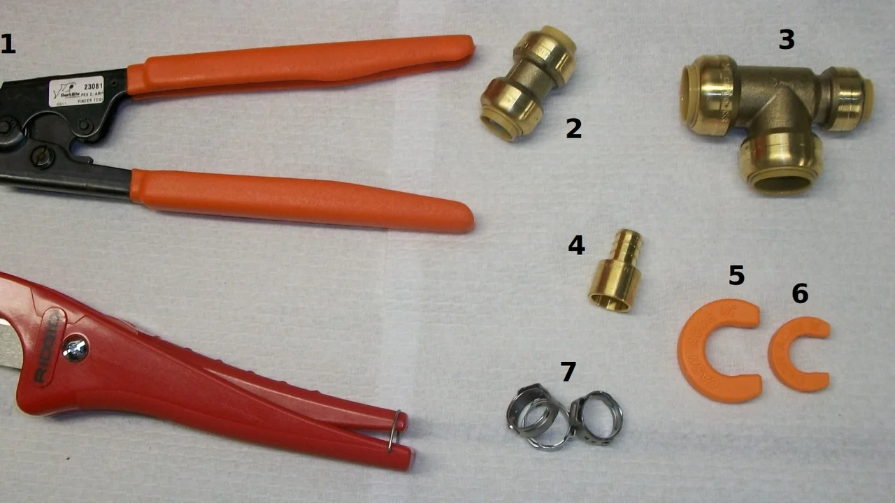 PEX plumbing installation tools and fittings, including orange SharkBite disconnect clips, photographed in 2011.